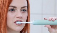 woman brushing her teeth