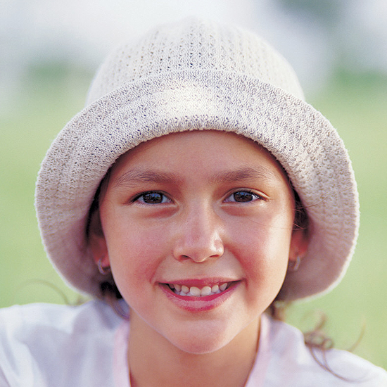 Little girl smiling outdoors